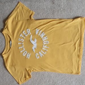 Yellow short-sleeved tee, brand Hollister, size XS.